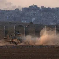 Israeli soldiers move on armored personnel carriers (APC) near the Israeli-Gaza border, in southern Israel, December 18, 2024